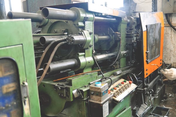 A worker operating machinery in a factory.