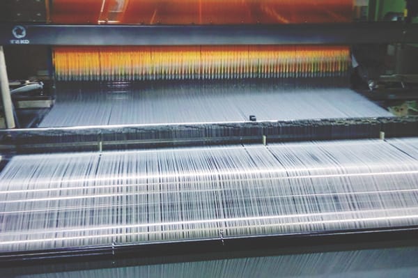 A machine producing large quantities of fabric.