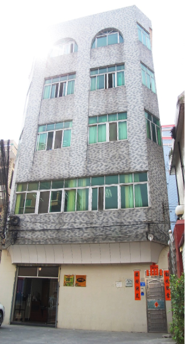 A building with a car parked in front.